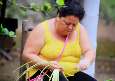 Woman weaving fibers for panama hats costa rica